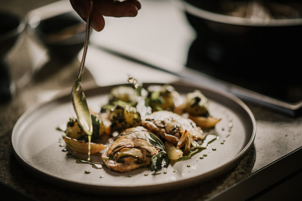 Schweinemedaillons auf Teller mit Pilzen, serviert von Starkoch Alexander Herrmann, fotografiert von Werbefotograf für Fissler