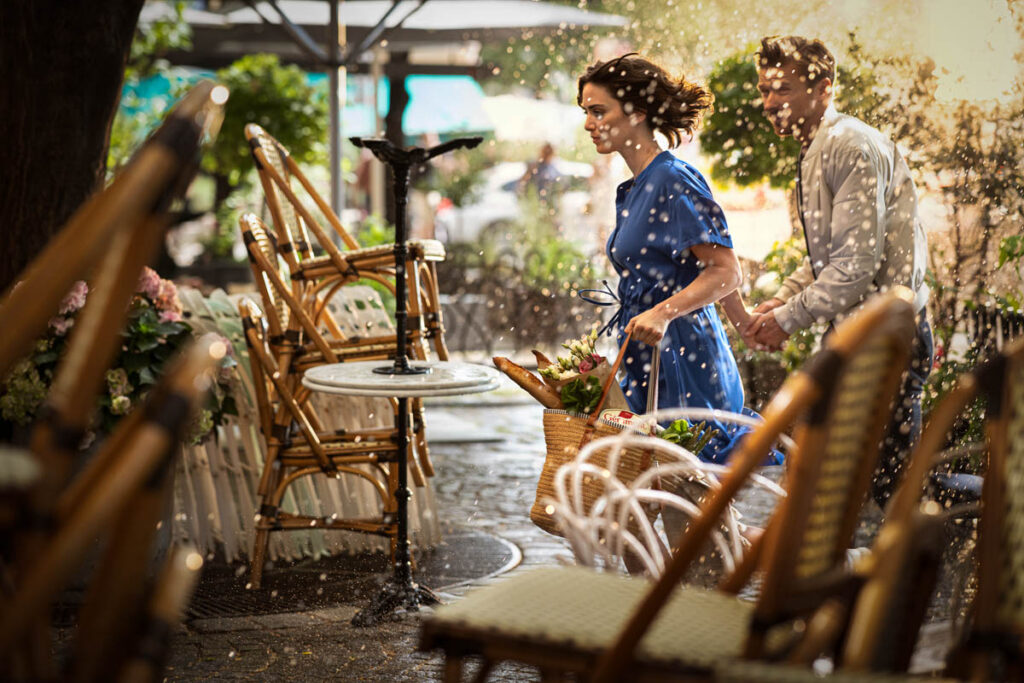 Paar rennt durch Regenguss mit Einkauf und Géramont Käse, emotionale Szene