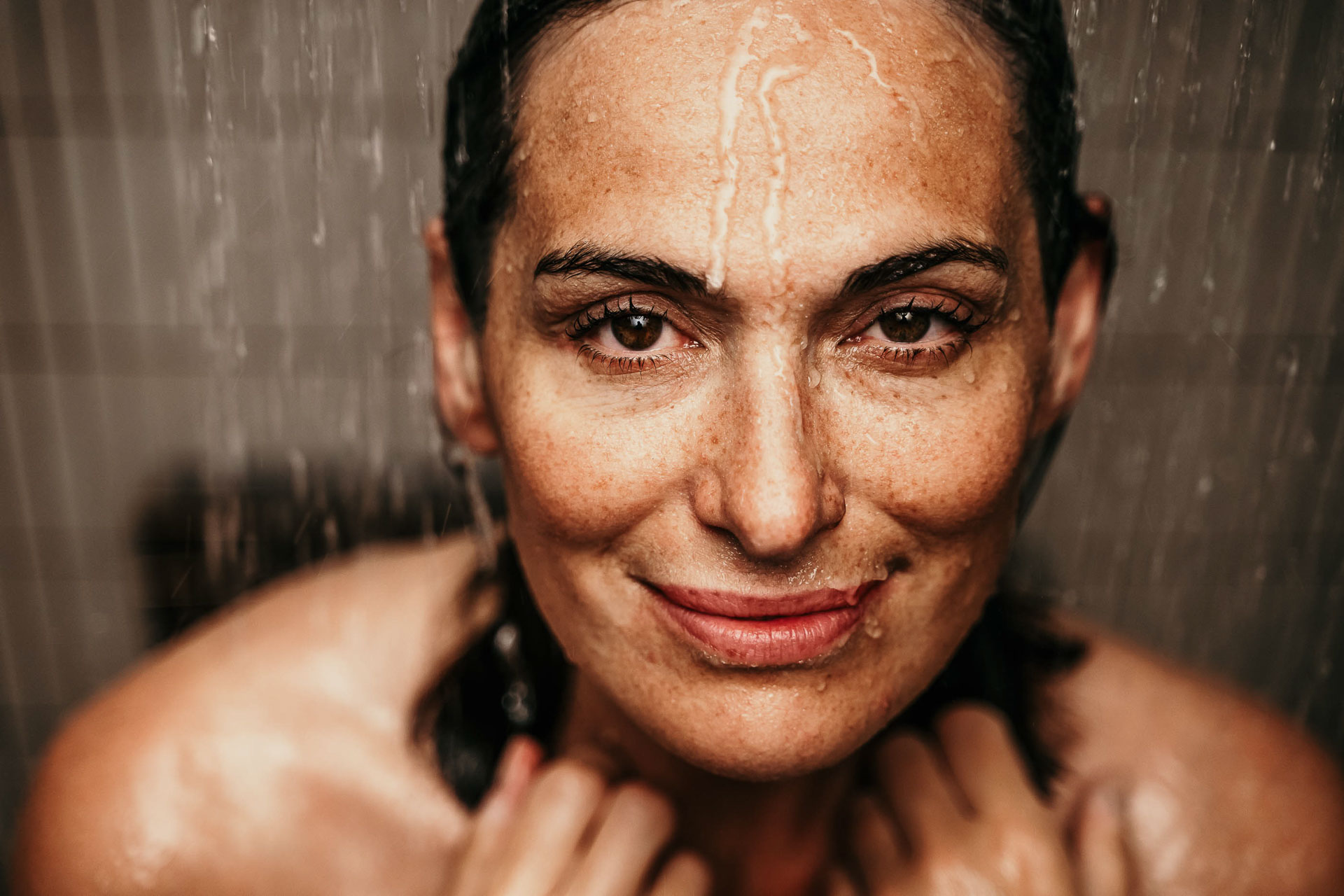 Businessfotografie Braunschweig: Businessportrait in Braunschweig – Frau unter der Dusche, emotionale und authentische Lifestyleaufnahme.